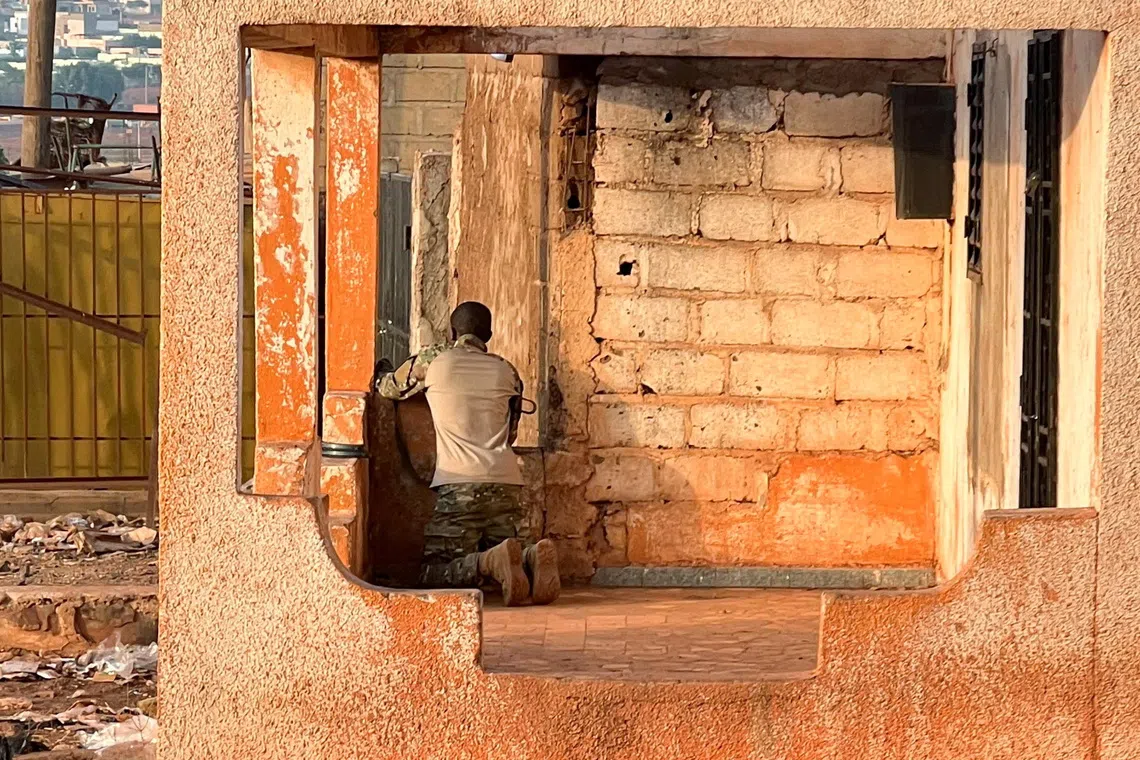 A Malian soldier stands in position with his weapon during an attack on Mali’s main military base Kati outside the capital Bamako, Mali, on April 25.