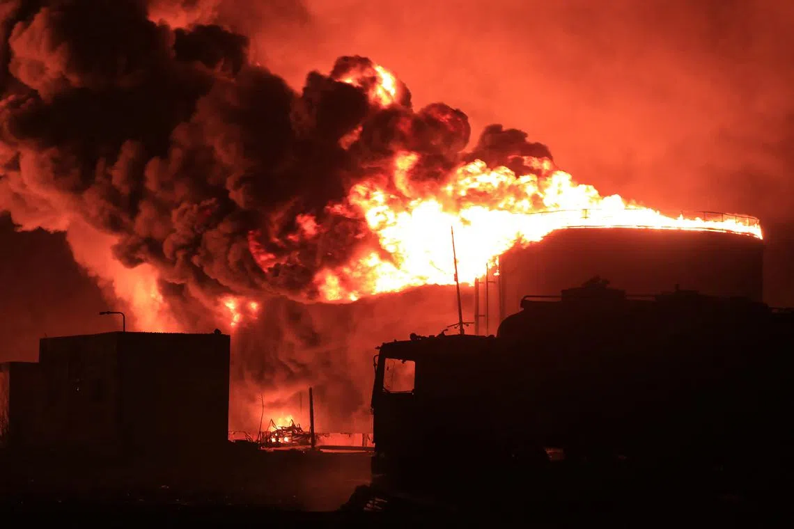 A giant fire erupts at an oil storage facility following Israeli strikes in Yemen's Houthi-held port city of Hodeida on July 20, 2024. 