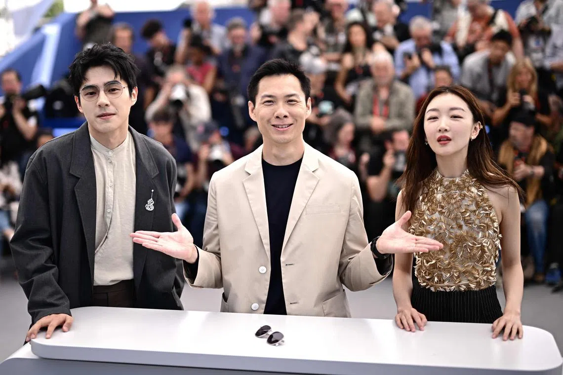 (From left) Chinese actor Liu Haoran, Singaporean director Anthony Chen and Chinese actress Zhou Dongyu pose during a photocall for the film The Breaking Ice at the 76th edition of the Cannes Film Festival in Cannes, southern France, on May 22, 2023. 