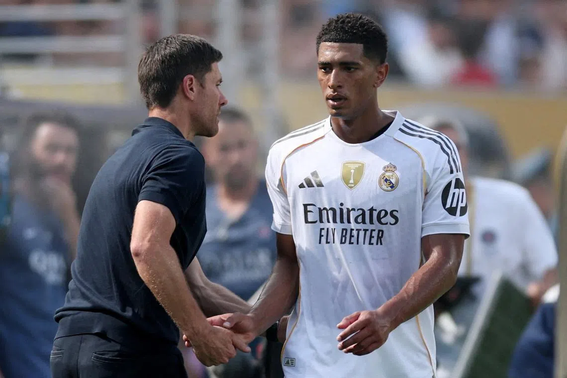 FILE PHOTO: Soccer Football - FIFA Club World Cup - Semi Final - Paris St Germain v Real Madrid - MetLife Stadium, East Rutherford, New Jersey, U.S. - July 9, 2025 Real Madrid's Jude Bellingham shakes hands with coach Xabi Alonso after being substituted REUTERS/Lee Smith/File Photo