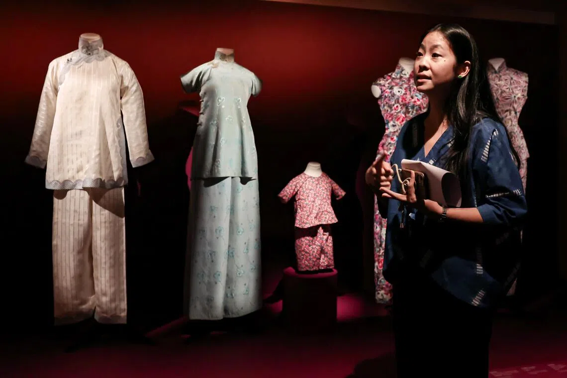 Curator Naomi Wang introducing the samfu attire on display during the preview of Exceptional/Everyday: New Acquisitions, New Perspectives exhibition at Peranakan Museum on Oct 27.