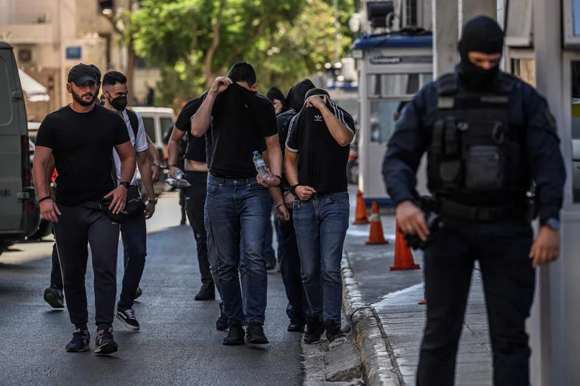 Football fans, most of them from Croatia, leave after being questioned by police in Greece over the stabbing of a Greek fan during violent clashes.