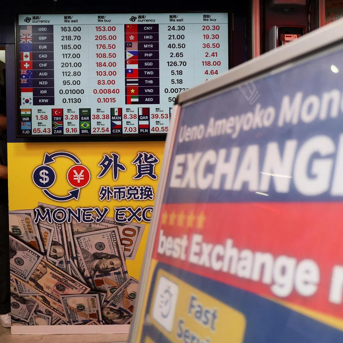 Exchange rates of Japanese Yen to the US dollar and several other foreign currencies are displayed at a money exchange shop in Tokyo.