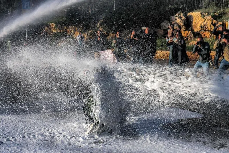 Israeli security forces use water cannon to disperse protesters that had gathered outside the Knesset, the Israeli Parliament, in Jerusalem on March 31, 2026.