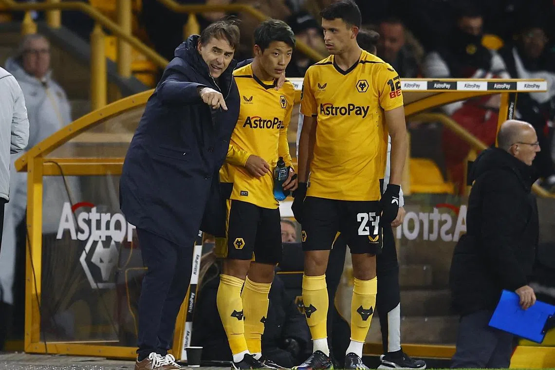 Soccer Football - Carabao Cup - Round of 16 - Wolverhampton Wanderers v Gillingham - Molineux Stadium, Wolverhampton, Britain - December 20, 2022
Wolverhampton Wanderers manager Julen Lopetegui talks to Hwang Hee-Chan and Matheus Nunes REUTERS/Peter Nicholls EDITORIAL USE ONLY. No use with unauthorized audio, video, data, fixture lists, club/league logos or 'live' services. Online in-match use limited to 75 images, no video emulation. No use in betting, games or single club	/league/player publications.  Please contact your account representative for further details.