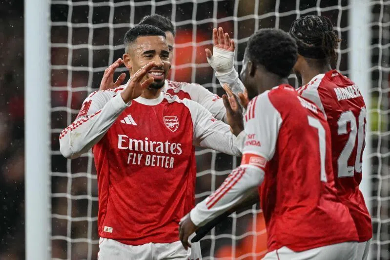 Arsenal's Brazilian striker Gabriel Jesus (left) celebrates with teammates after scoring the team's fourth goal against Wigan Athletic at the Emirates Stadium in London on Feb 15.