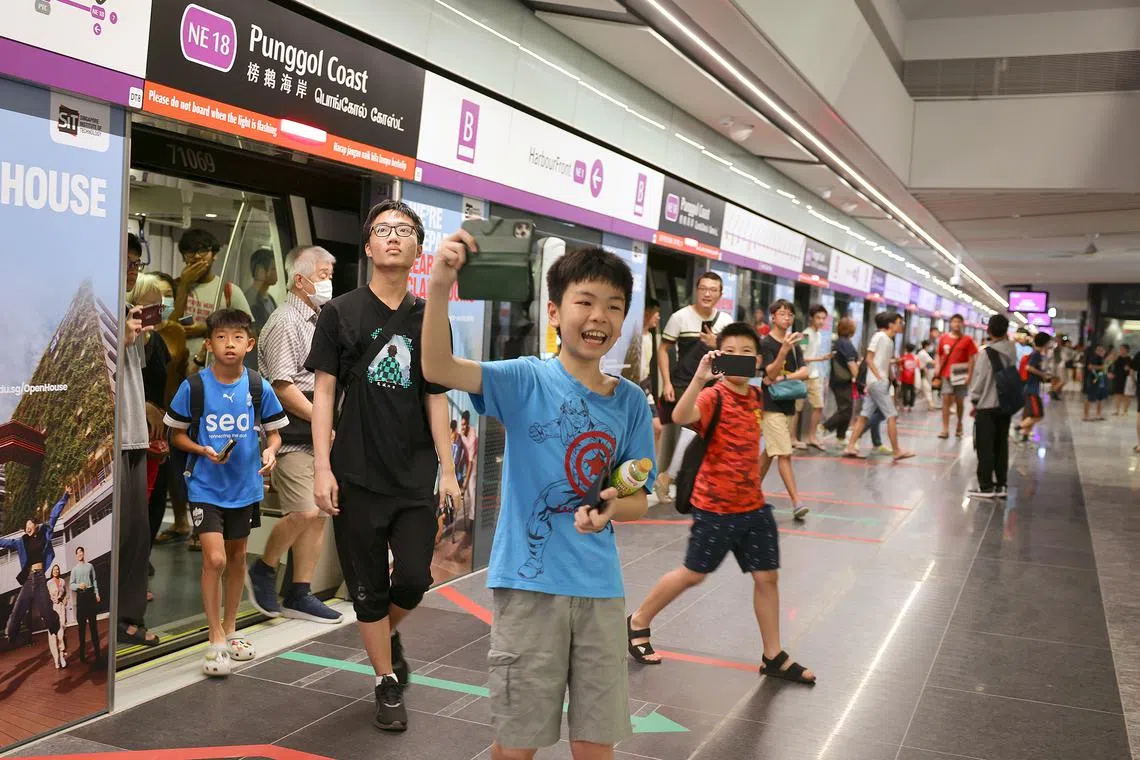 The first passengers arriving at the new Punggol Coast MRT station on Dec 10.