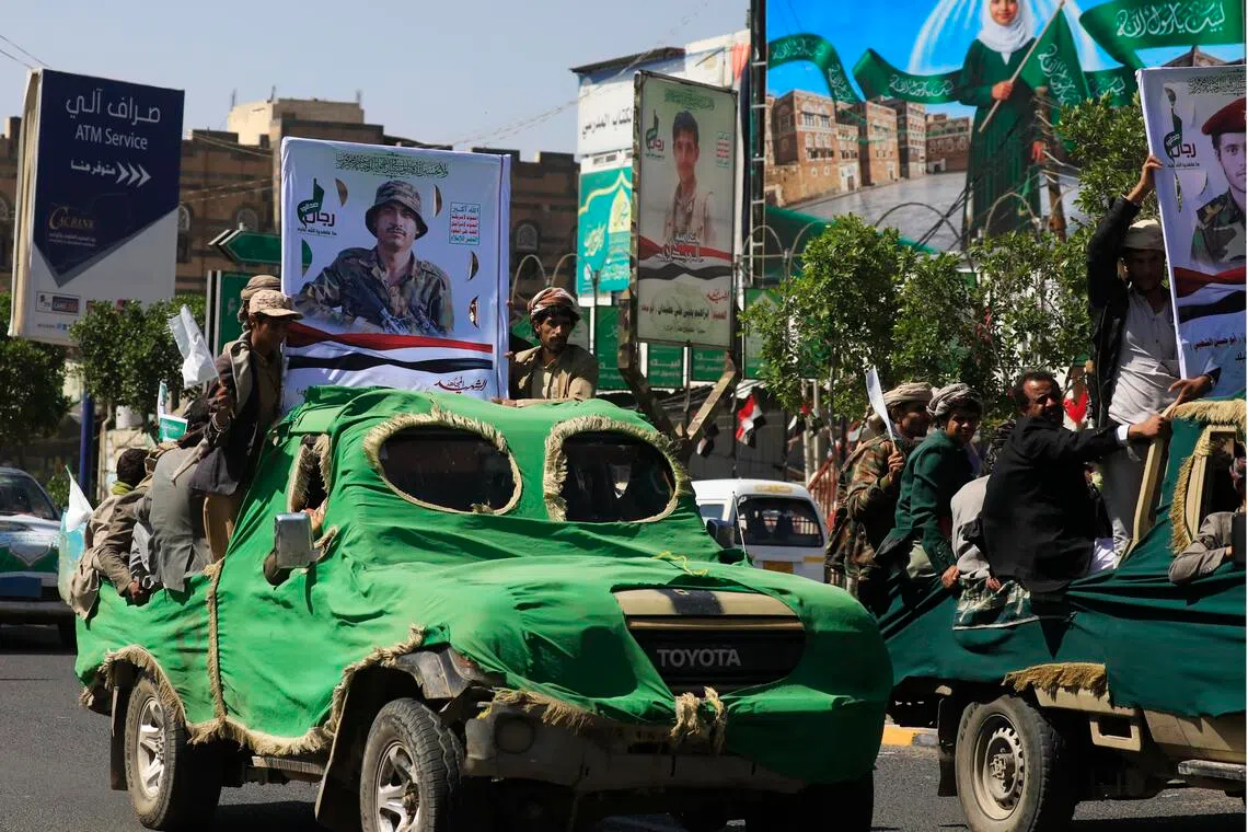 Iran-backed Houthi militants taking part in a funeral procession in Sanaa, Yemen, on Sept 24, carrying portraits and coffins of fellow fighters killed in action.