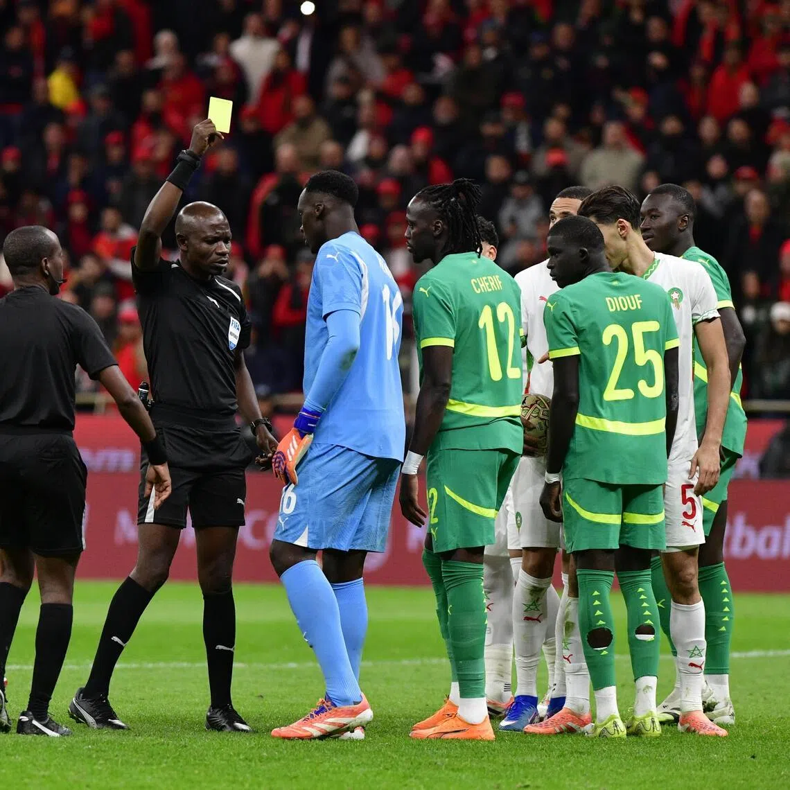 Referee Jean-Jacques Ngambo Ndala giving a yellow card to Senegal goalkeeper Edouard Mendy in the Africa Cup of Nations final on Jan 18.
