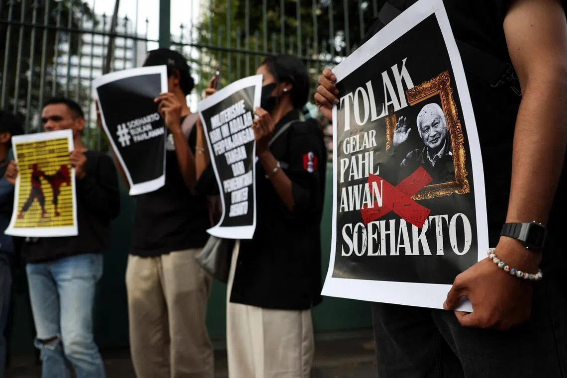 Activists during a protest against former Indonesian President Suharto, who was named a national hero, outside the Ministry of Culture building in Jakarta, Indonesia, on Nov 10.
