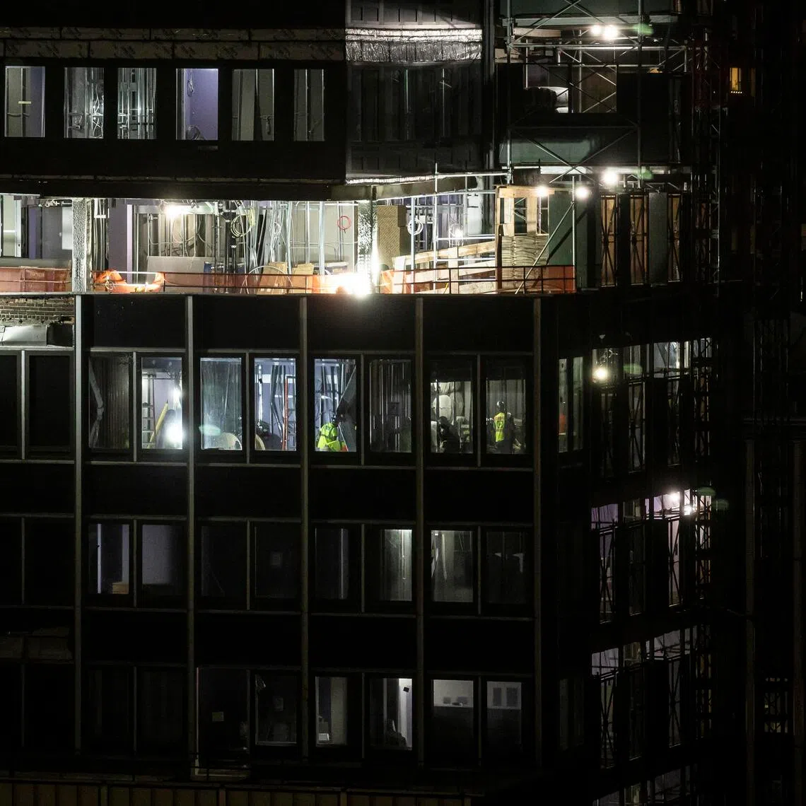 Emergency personnel place structural shoring in a high-rise building at risk of collapse in Midtown Manhattan, New York City, on July 7.