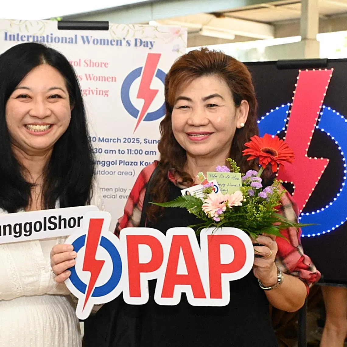 Pasir Ris-Punggol GRC MP Yeo Wan Ling (left) poses with a resident at an event marking International Women's Day on March 30.