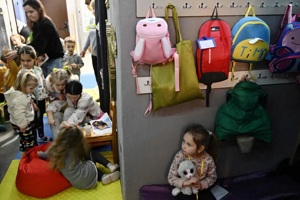 Children play in an air-raid shelter in the cellar of a kindergarten after an alarm signal in Kyiv on March 20. The staff try to reduce the psychological impact on children who can barely remember a time without sirens and fear. 