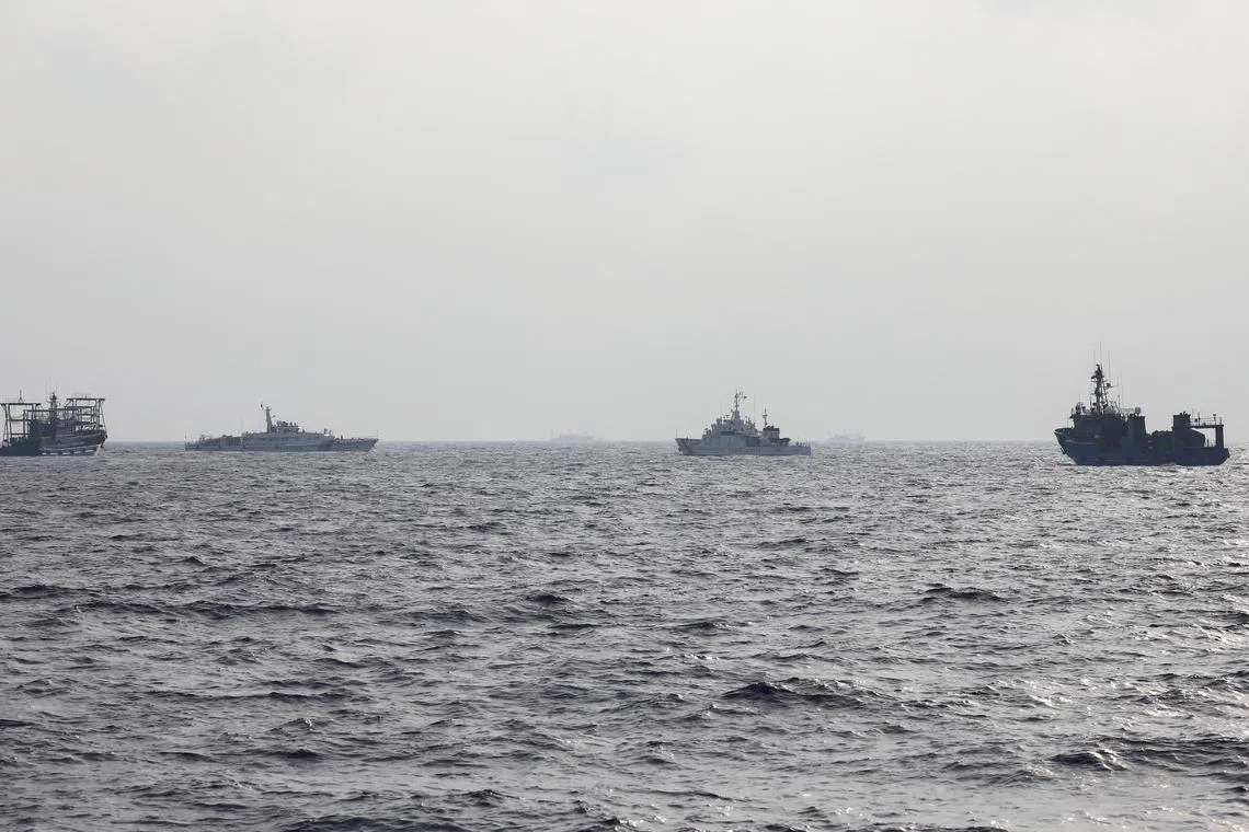 FILE PHOTO: A Philippine Coast Guard ship is seen surrounded by Chinese maritime militia vessels and a Chinese Coast Guard ship during a resupply mission for Filipino troops stationed at a grounded warship in the South China Sea, October 4, 2023. REUTERS/Adrian Portugal/File Photo