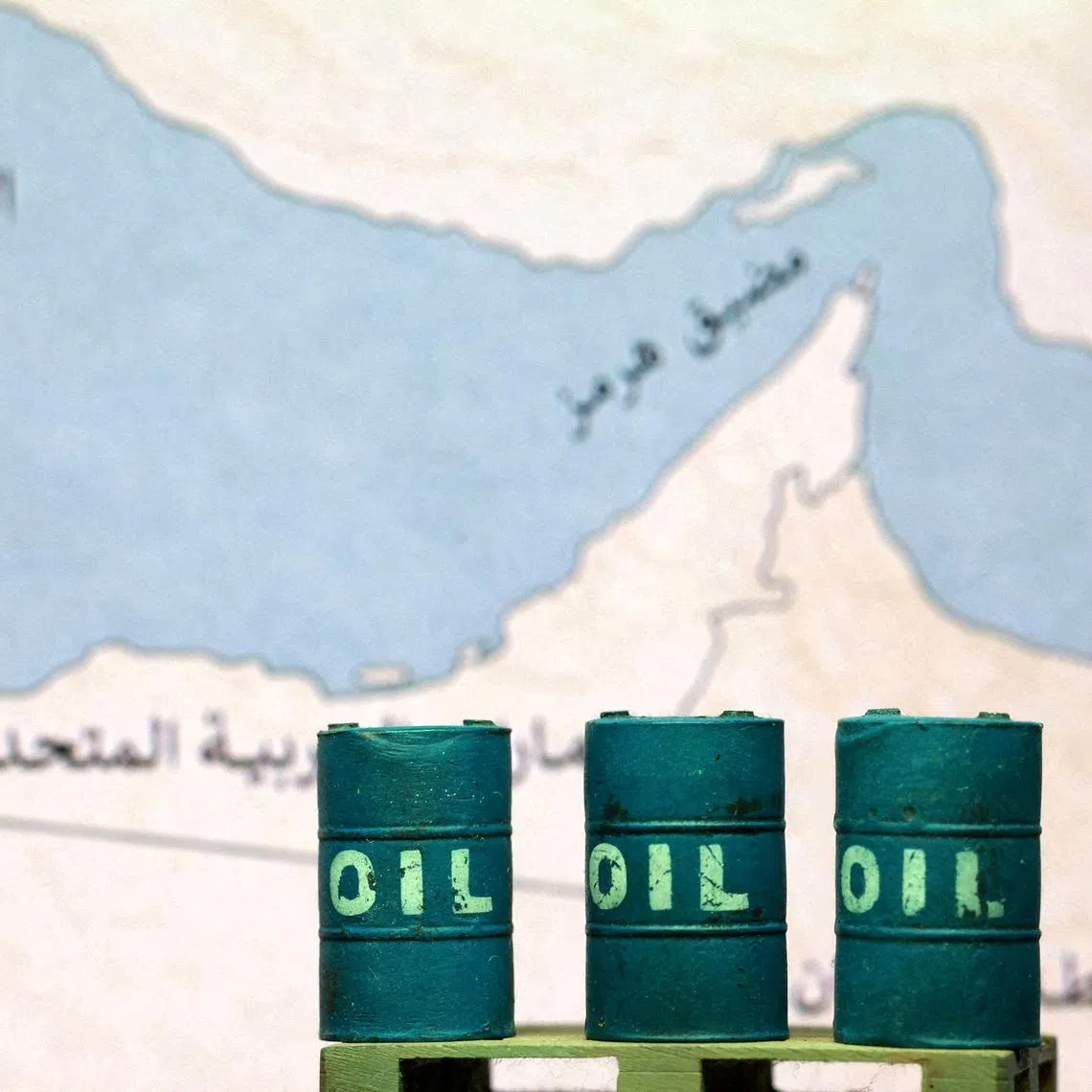 A map showing the Strait of Hormuz, also known as Madiq Hurmuz, and 3D printed oil barrels are seen in this illustration taken March 26, 2026. REUTERS/Dado Ruvic/Illustration