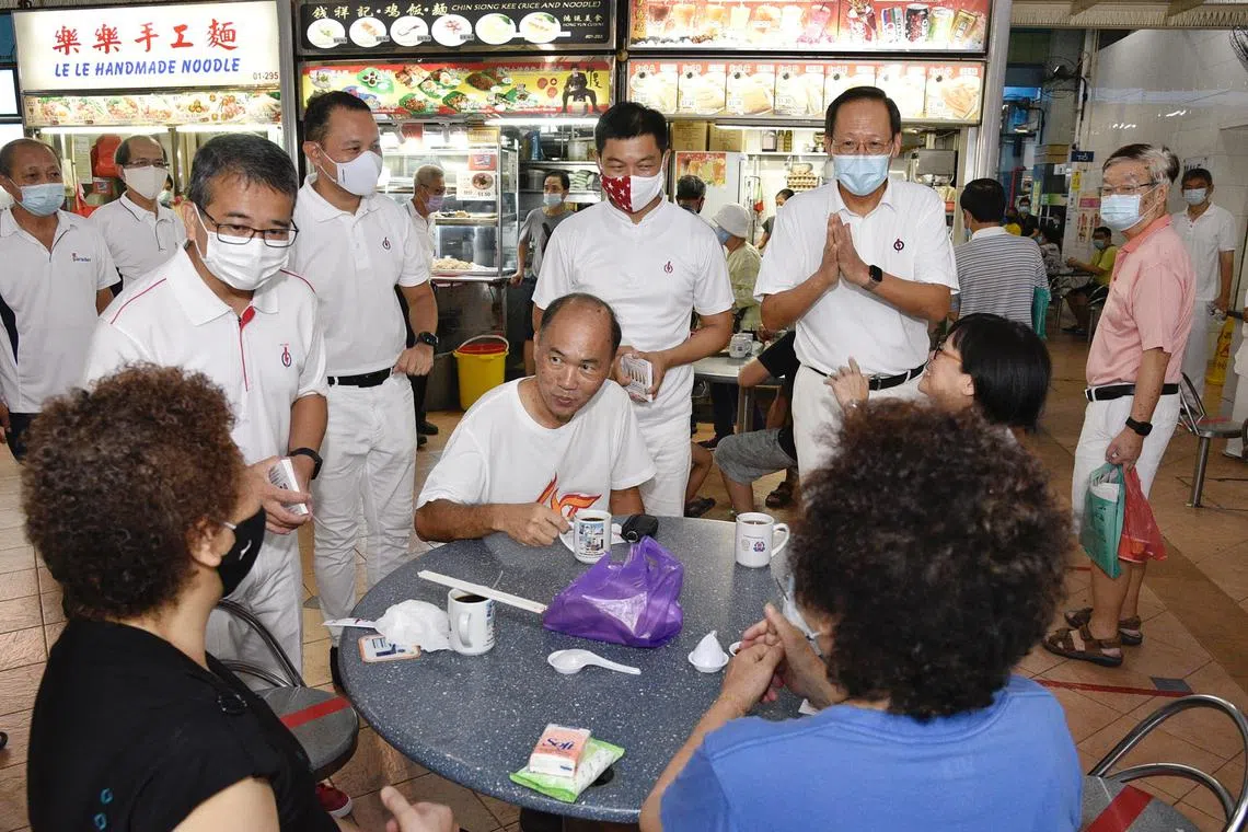 Mr Tan Chuan-Jin (standing, second right) with (from left) PAP Marine Parade GRC candidates Edwin Tong, Mohd Fahmi Aliman and Tan See Leng on a walkabout in July 2020. 