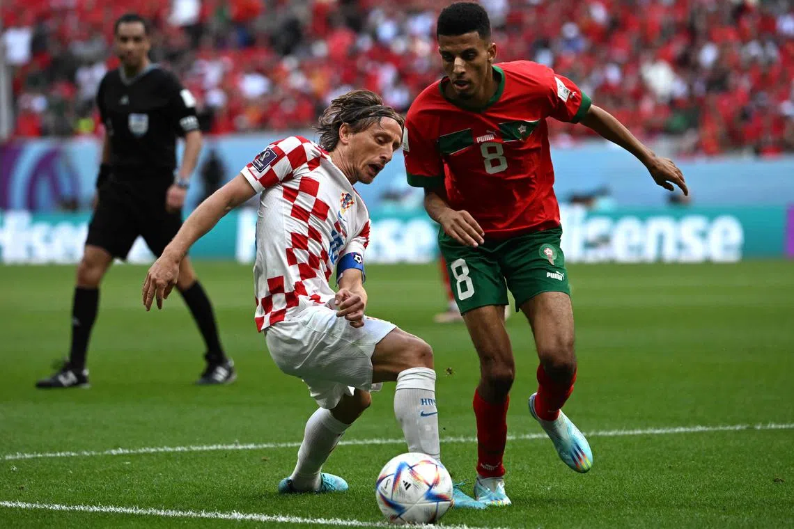 Croatia's Luka Modric and Morocco's Azzedine Ounahi fight for the ball during the Qatar World Cup Group F match at the Al-Bayt Stadium on Nov 23.