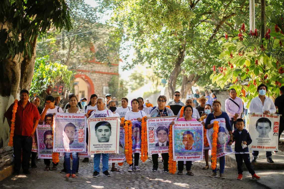 Relatives of the 43 missing students of the Ayotzinapa teacher training college hold banners on Nov 15, 2022.