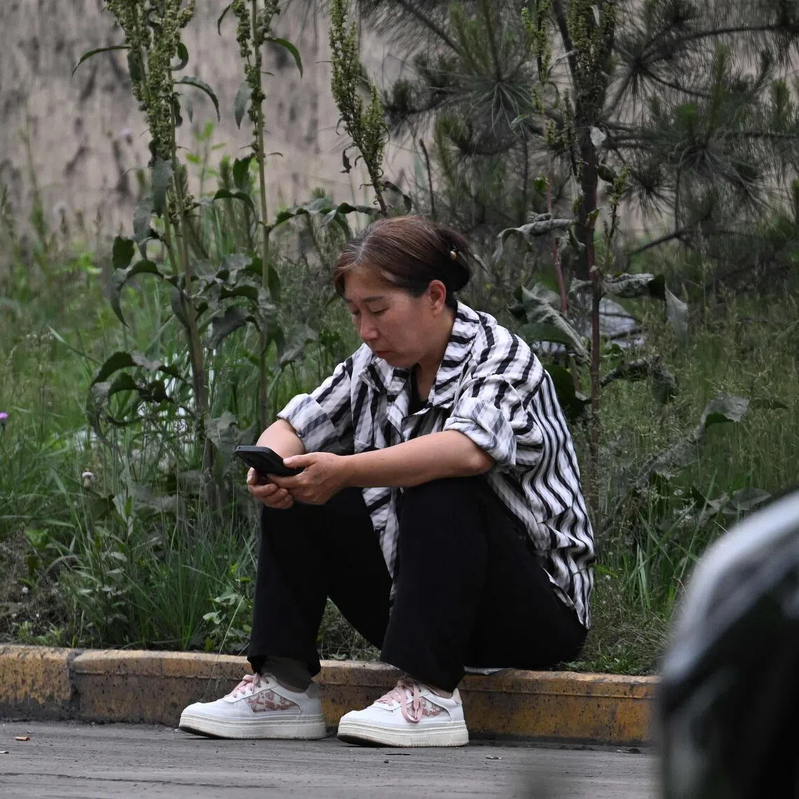 A relative of a missing miner waits for news outside the Liushenyu coal mine, where an explosion killed dozens.
