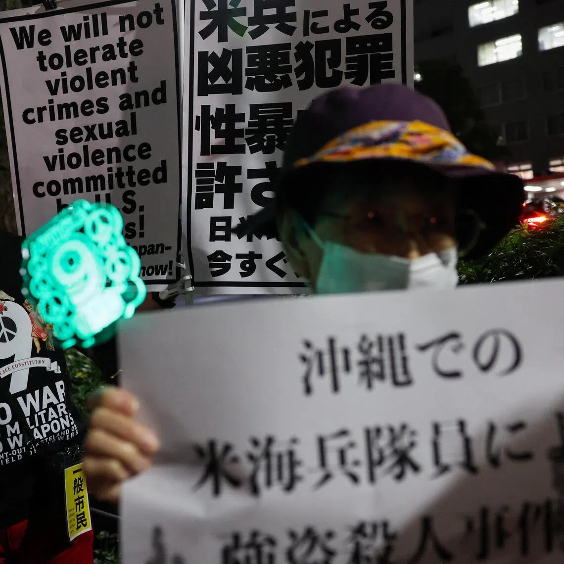 Demonstrators hold placards during a protest outside Foreign Ministry building on Oct 8 following the killing of a Japanese woman in Okinawa, for which a US Marine is a suspect.