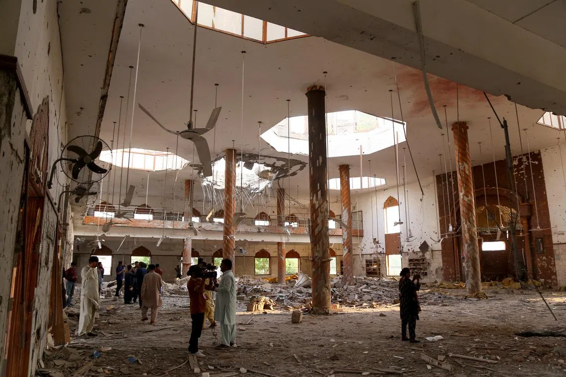 FILE PHOTO: Members of the media film the inside of a building after it was hit by an Indian strike in Bahawalpur, Pakistan, May 7, 2025. REUTERS/Stringer/File Photo