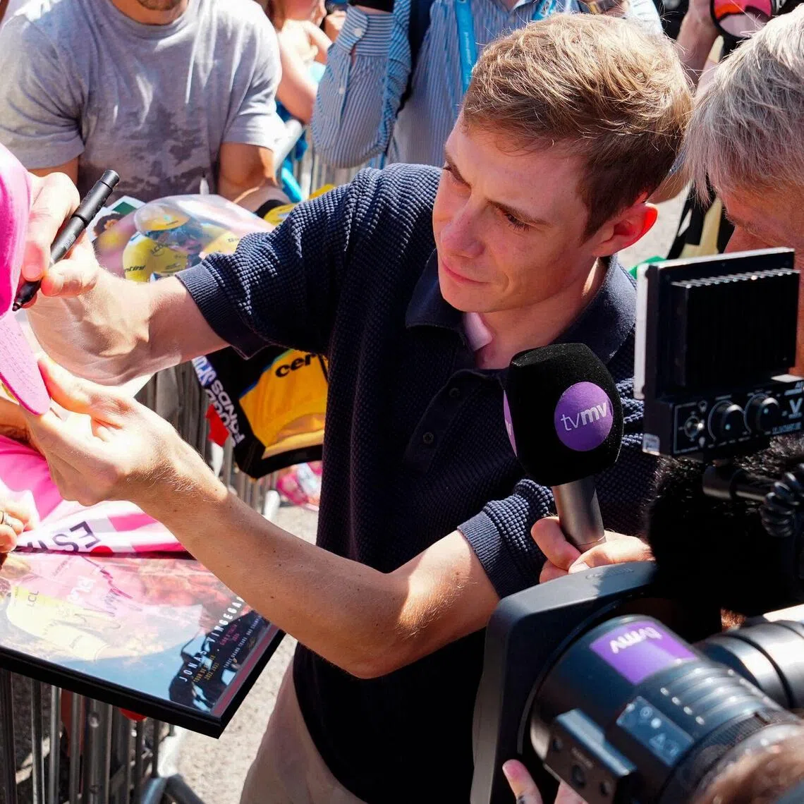 Danish cyclist Jonas Vingegaard signs autographs for fans in Glyngoere, Denmark on July 30, during the second stage of the PostNord Denmark Tour.