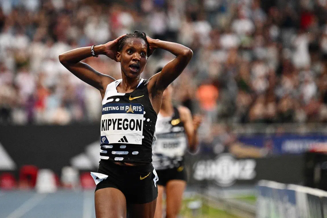 Kenya's Faith Kipyegon reacts as she breaks the world record in the women's 5,000m event during the Diamond League event in Paris.