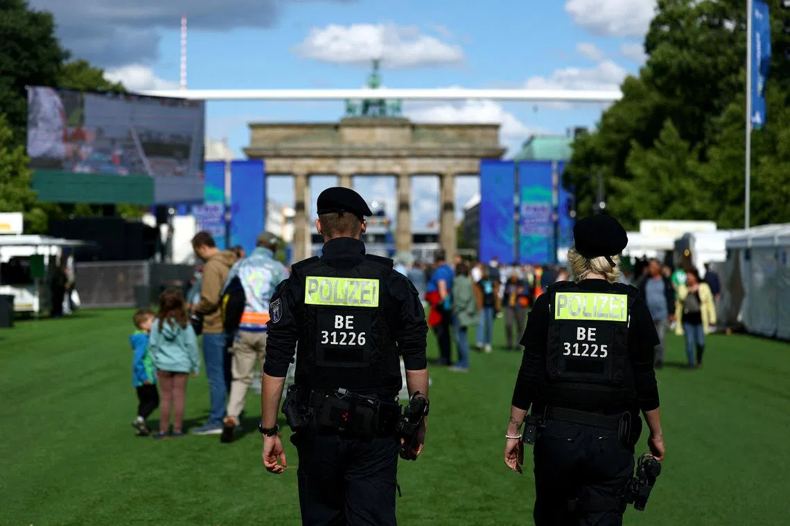 Police patrols at the official Fan Mile on 17th June Street, close to the Brandenburg Gate, during its pre-opening in Berlin, Germany, June 12, 2024. REUTERS/Lisi Niesner