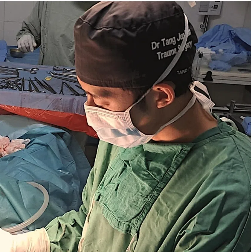 Tan Tock Seng Hospital specialist trauma surgeon Tang Jun Han conducting a diaphragm repair surgery at the Ameth-Bek Hospital.
