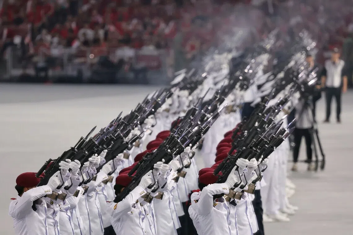 The ceremonial feu de joie echoing across the venue in a salute marking Singapore's birthday during National Day Parade 2026 at the National Stadium on Aug 9, 2026. ST PHOTO: KEVIN LIM