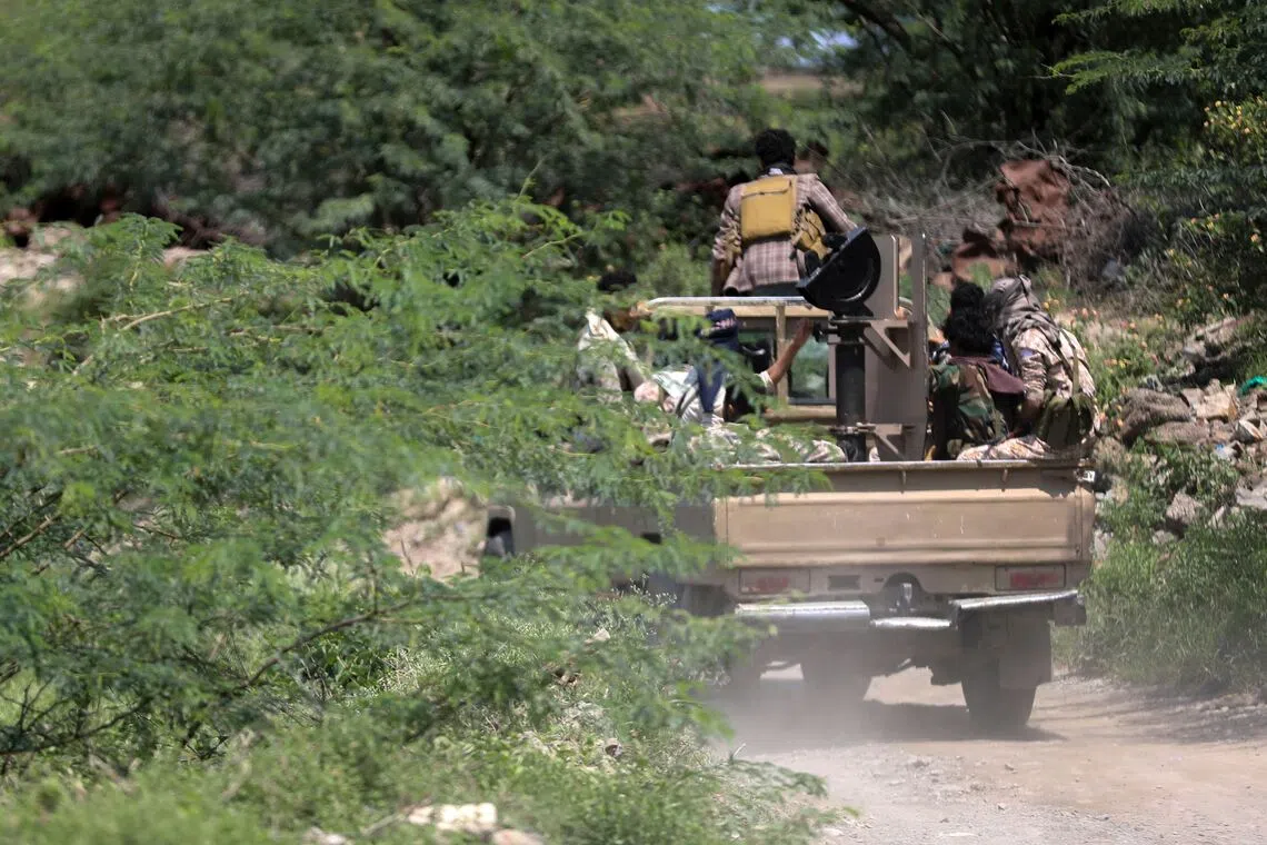 Saudi-backed Yemen government soldiers ride in a pick-up truck near the Jabal Han front, west of the city of Taiz, following fierce battles earlier in the day on Oct 3.