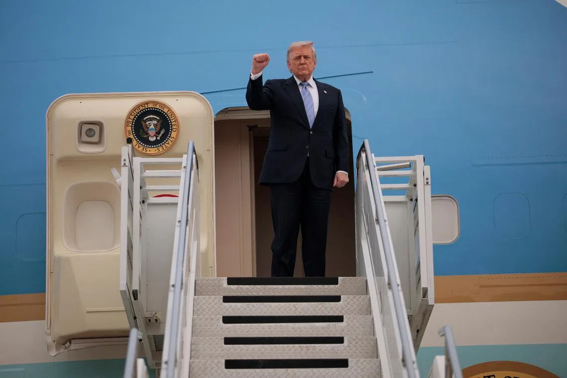 US President Donald Trump gestures as he departs Beijing Capital International Airport aboard Air Force One, in Beijing, China, on May 15.