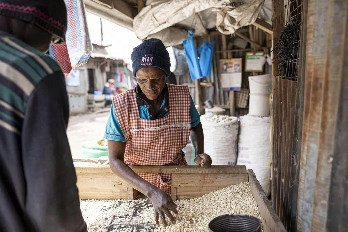 A vendor sells maize at a market stall in Nairobi, Kenya.