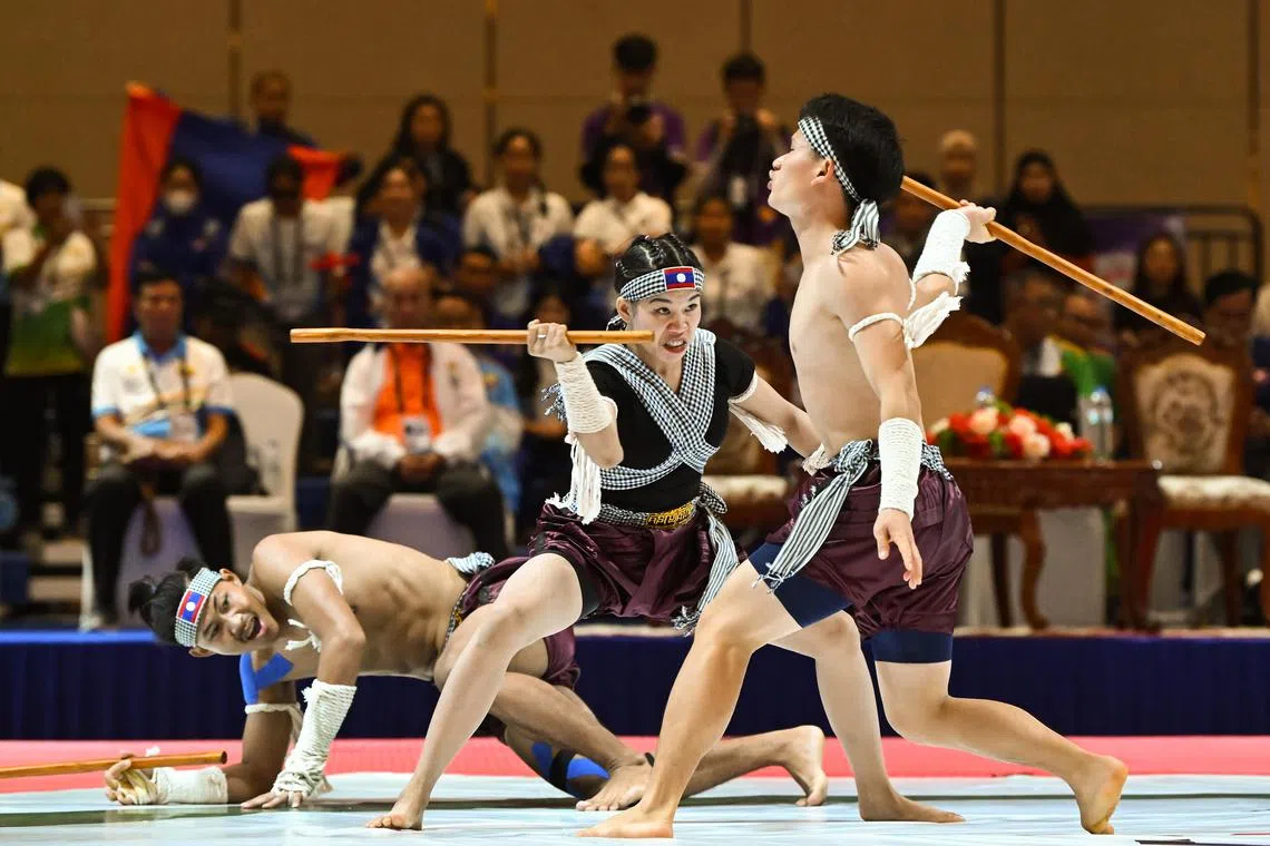 The standardised programme will see the SEA Games feature a maximum of four regional or tradition sports for at least the next three editions.  This means sports like kun bokator, a Cambodian martial art that made its Games debut today, would most likely not be featured in the upcoming Games.

ST20230508-202366475813-Lim Yaohui-jondiary09/
Daokham Bouapha, Khamser Va and Koneta Chanheuangseng from Laos in the Mixed 1 Women Defence Against with 2 Men Group Performance in Kun Bokator at Chroy Changvar Convention Center on May 8, 2023. They got a joint bronze medal with a score of 8.17.
The 2023 Southeast Asian Games, commonly known as the 32nd Southeast Asian Games, or the 32nd SEA Games, and commonly known as Cambodia 2023, will be the 32nd edition of the Southeast Asian Games, a biennial sports multi-sport event which will be held from 5 to 17 May 2023 in Phnom Penh, Cambodia.
(ST PHOTO: LIM YAOHUI)