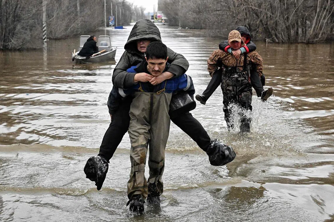 Rescuers evacuating residents from the flooded part of the city of Orsk, Russia's Orenburg region, on April 8, 2024.
