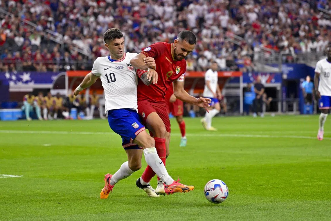 Jun 23, 2024; Arlington, TX, USA; Bolivia defender Luis Haquin (4) and United States forward Christian Pulisic (10) chase the ball during the second half in a 2024 Copa America match at AT&T Stadium. Mandatory Credit: Jerome Miron-USA TODAY Sports