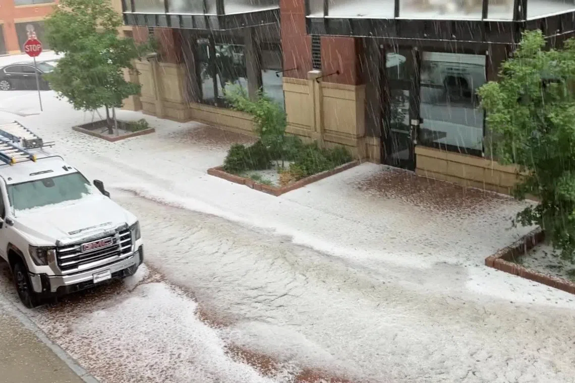 View of a flooded street during a hail storm in Boulder, Colorado, U.S. on June 12, 2023 in this screen grab taken from a social media video. 