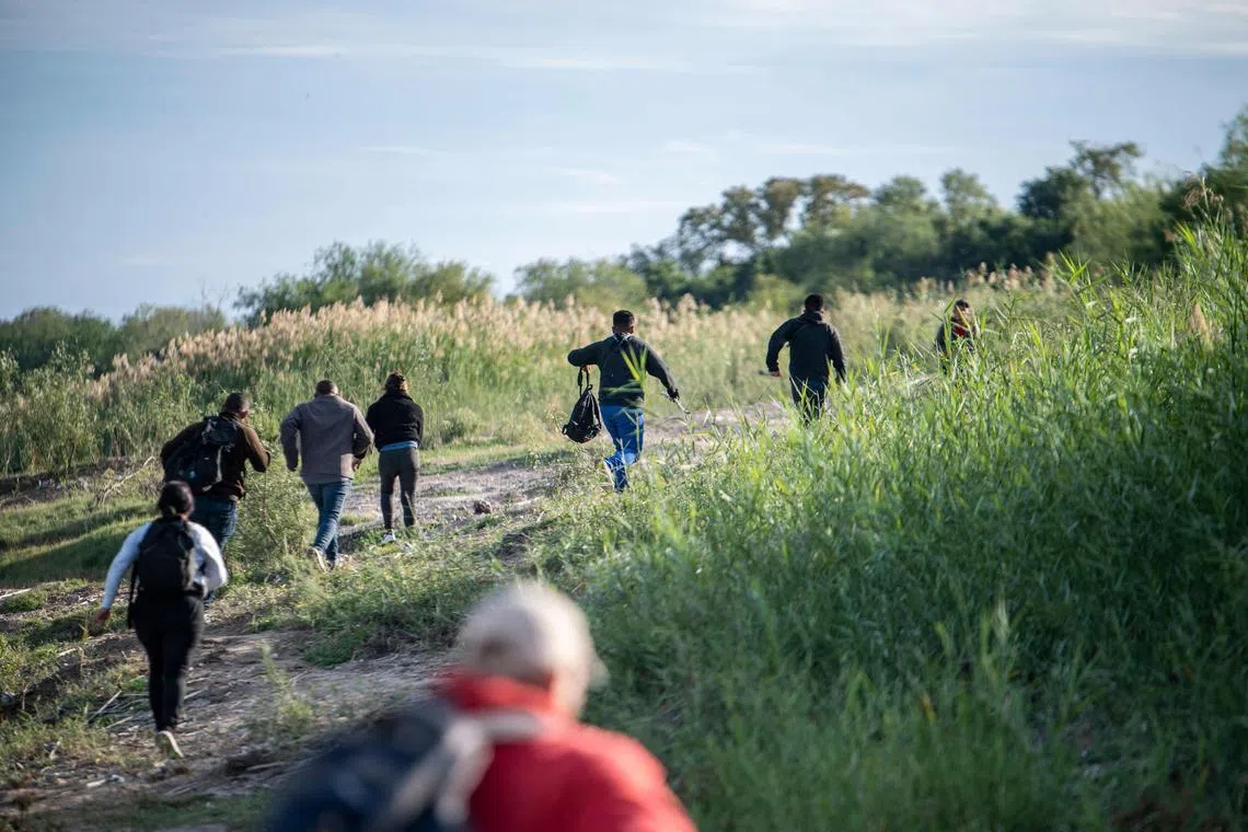 Migrants look for a place to cross the Rio Grande from Mexico to the US, in November 2022.