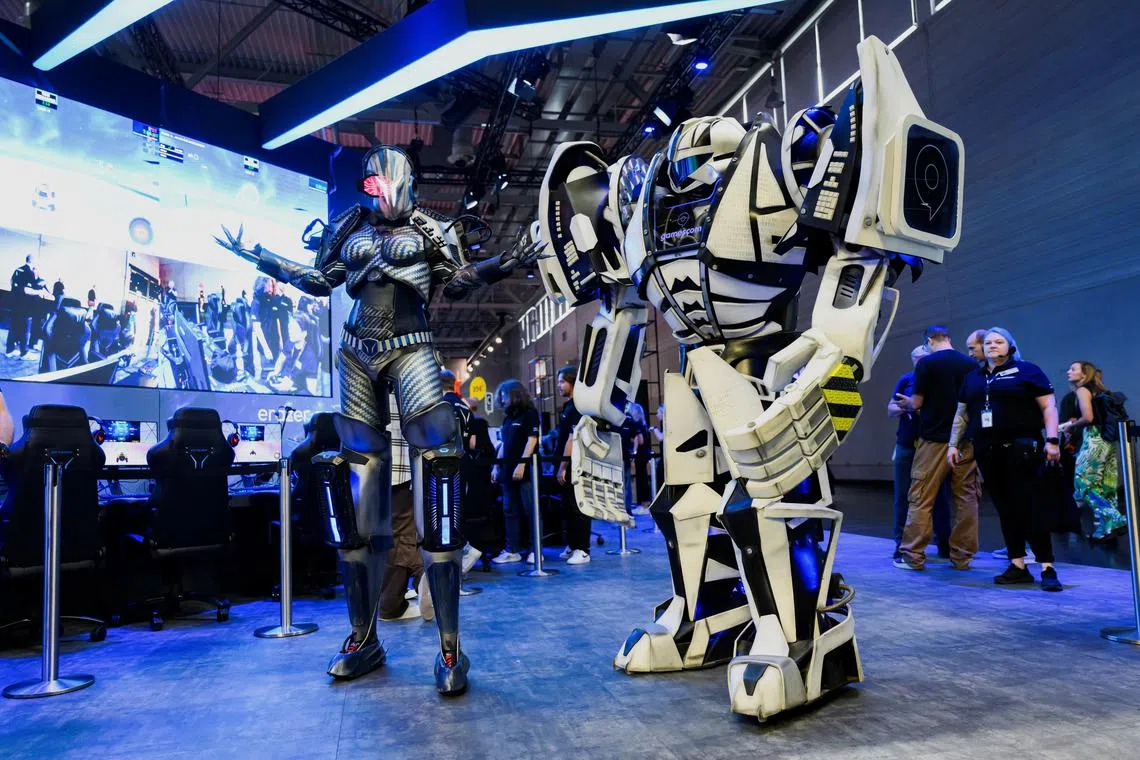 Two people in costumes are seen during the 2024 Gamescom computer and video game industry event in Cologne on Aug 21.
