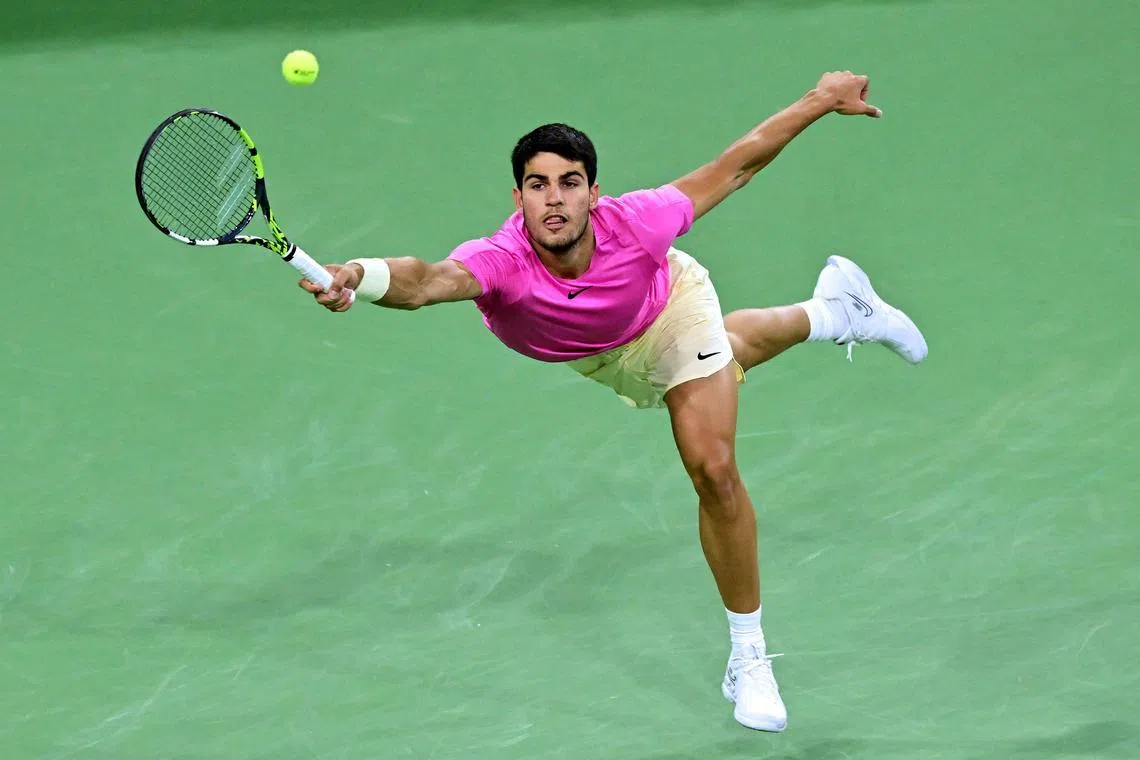 Spain's Carlos Alcaraz reaching for a forehand return to Canada's Felix Auger-Aliassime during their Indian Wells Masters quarter-final tennis match in Indian Wells, California, which Alcaraz