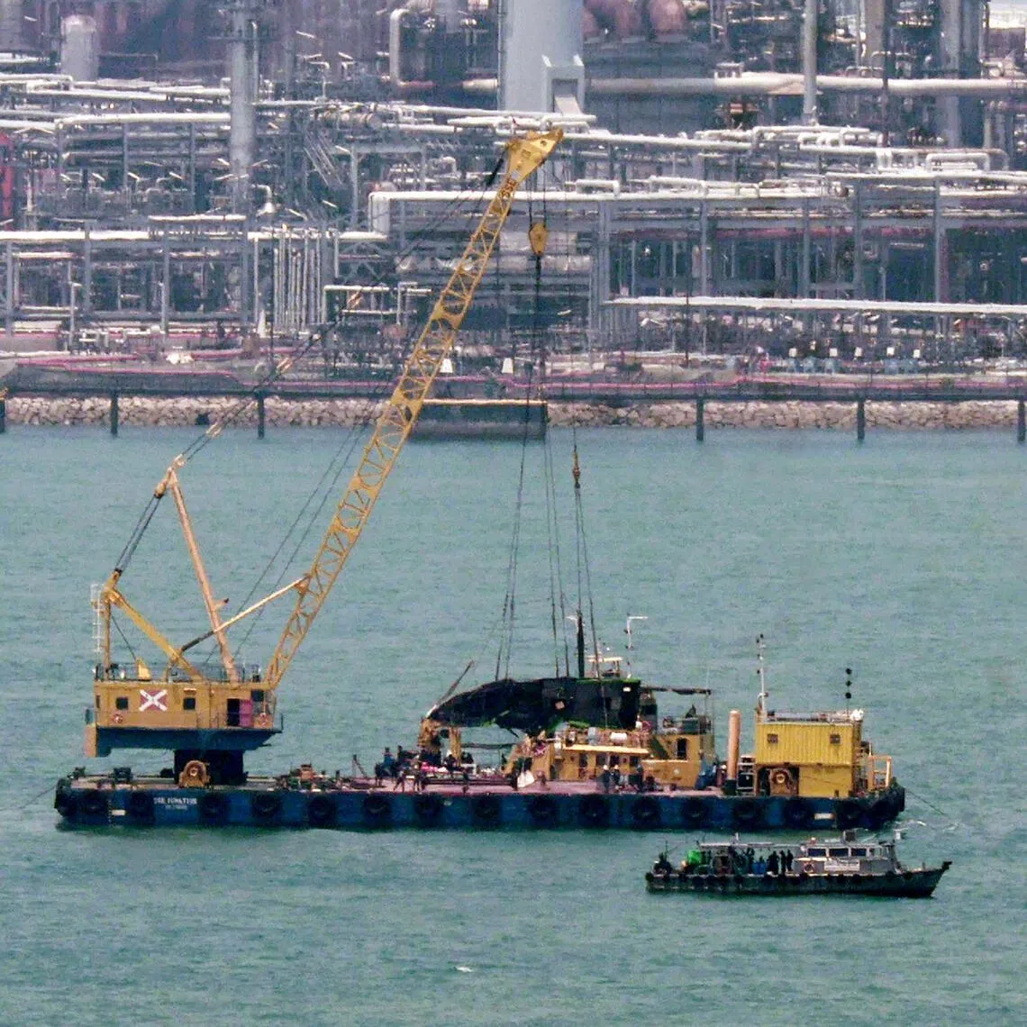 Salvage operations being conducted for a boat following a collision off the Southern Islands, on March 30. The body of a man missing since the accident was found on April 5.