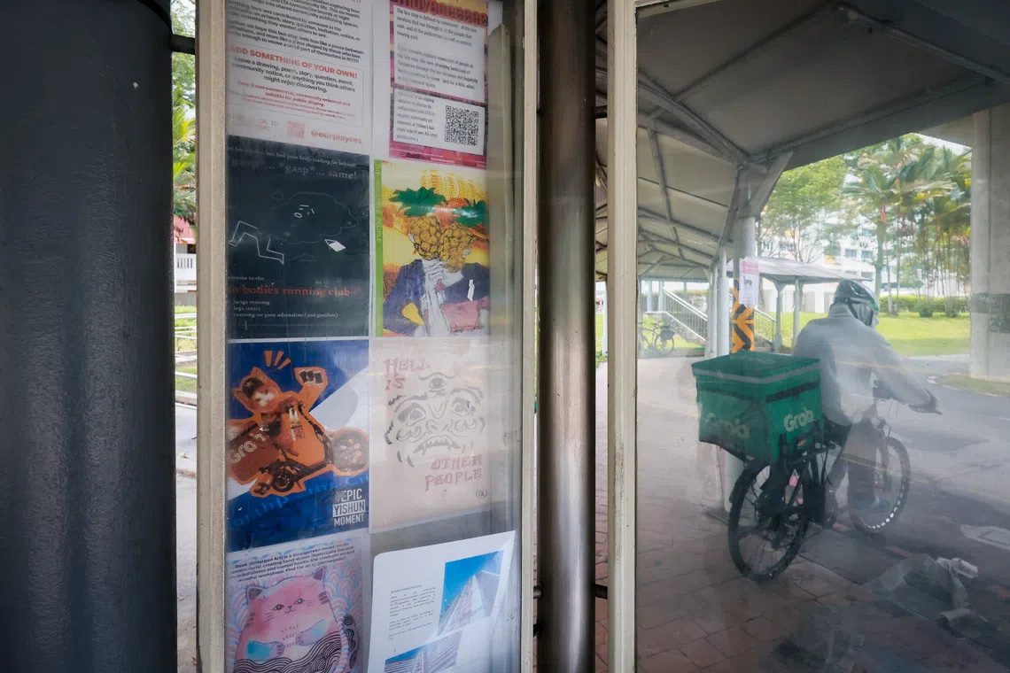 Volunteers refresh the noticeboards at eight bus stops in Yishun at the start of each month.