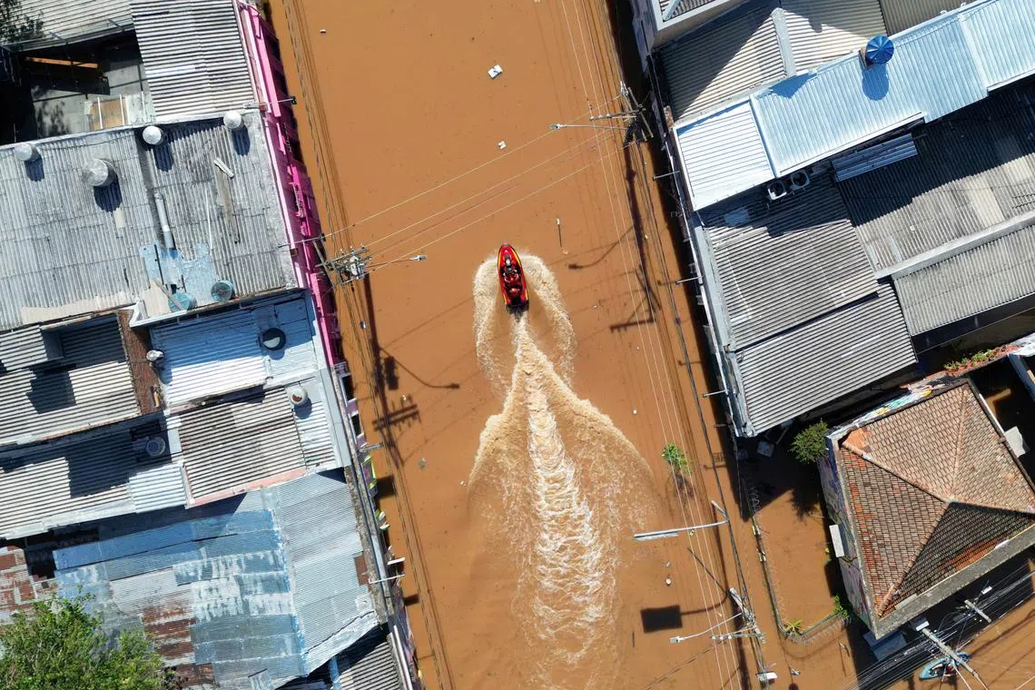 Rescue workers driving a boat at a flooded street in Porto Alegre in Brazil on May 7, 2024.   