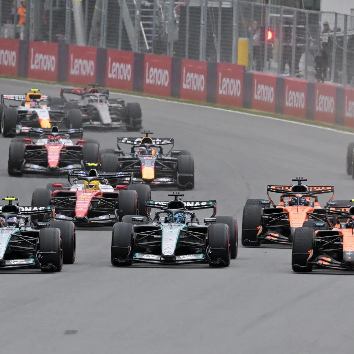 May 24, 2026; Montreal, Quebec, CANADA;  Mercedes driver Kimi Antonelli (12) and Mercedes driver George Russell (63) and McLaren driver Lando Norris (1) lead in the first turn at the start of the Lenovo Grand Prix Du Canada at Circuit Gilles-Villeneuve. Mandatory Credit: Eric Bolte-Imagn Images