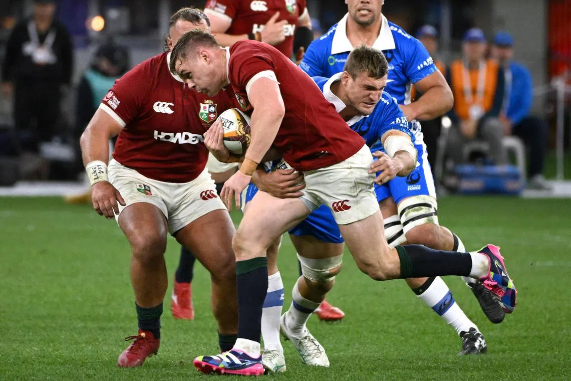 British and Irish Lions player Garry Ringrose is tackled by Western Force’s Nick Champion de Crespigny in their rugby game at Optus Stadium in Perth on June 28, 2025.