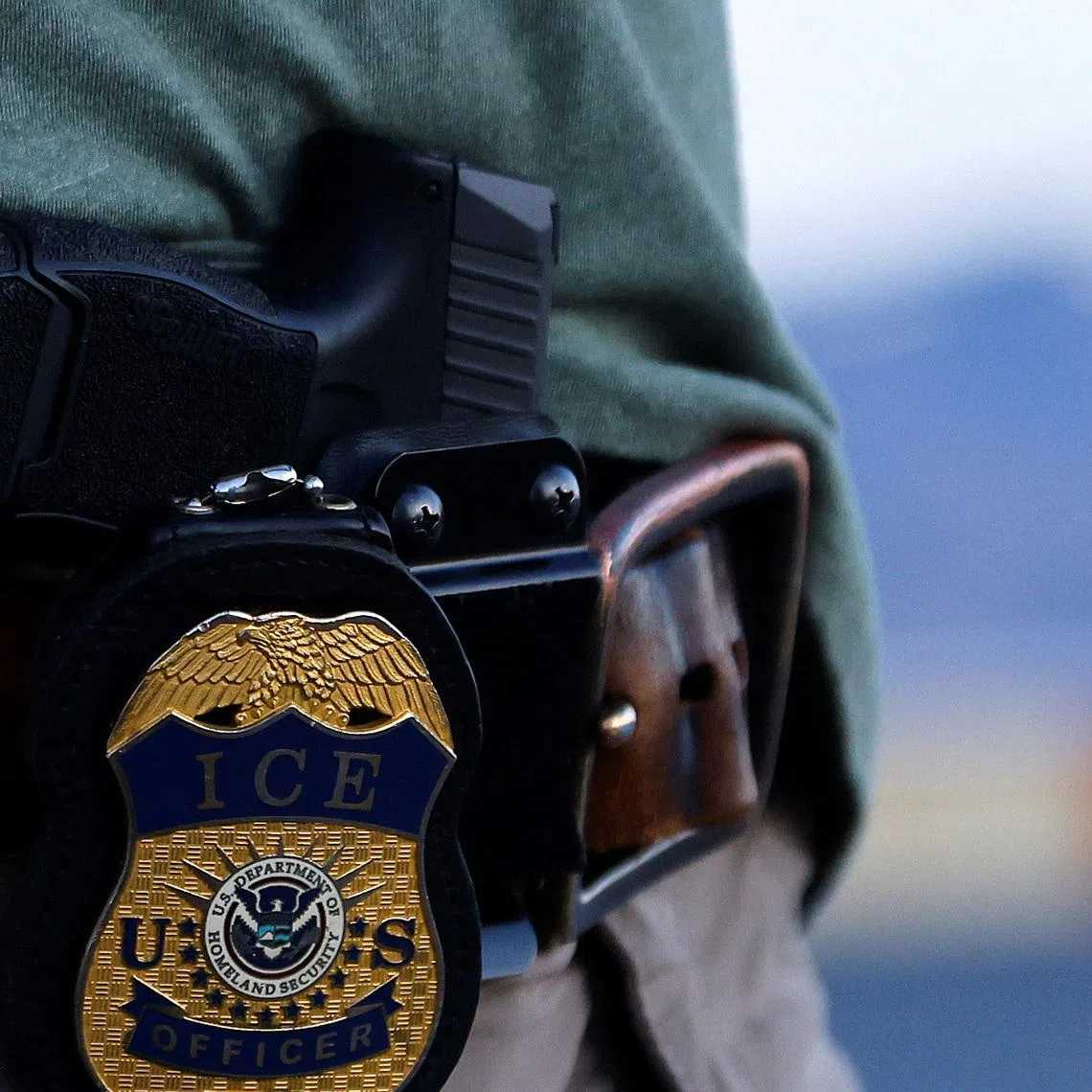 FILE PHOTO: The badge of a U.S. Immigration and Customs Enforcement (ICE) agent is seen at the airport in El Paso, Texas, U.S., May 10, 2023. REUTERS/Jose Luis Gonzalez/File Photo
