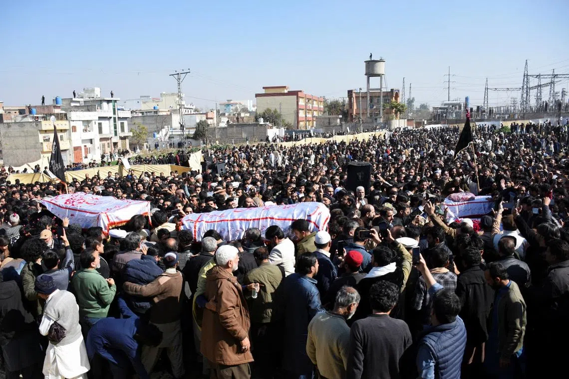 People gather to attend a funeral for victims following the suicide explosion at a Shi'ite mosque in Islamabad, on Feb 7.
