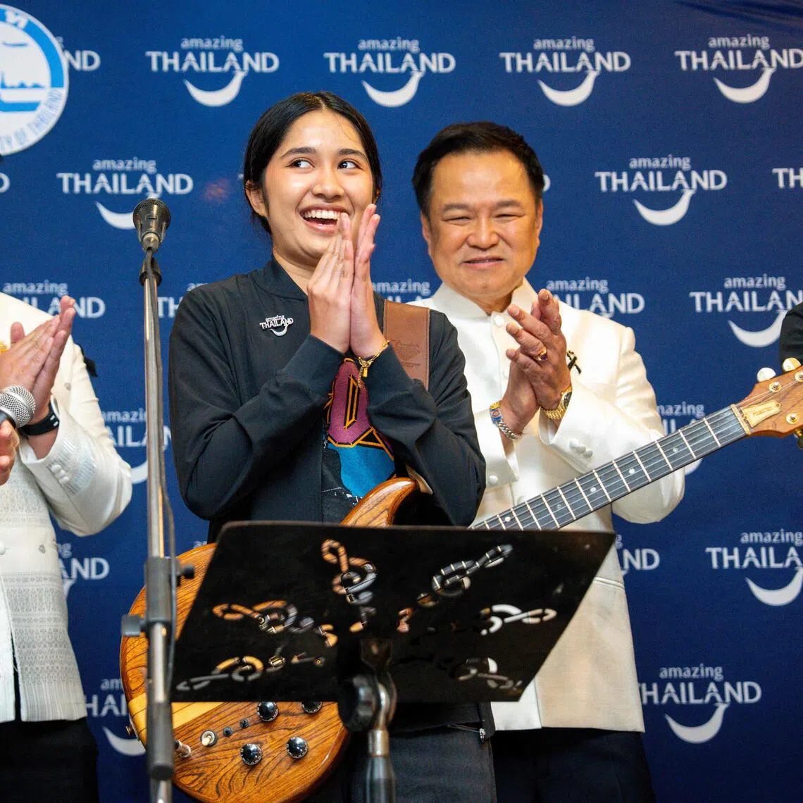 This photo taken on July 14, 2026 shows Thai musician Rattikarn "Nene Royal" Amloy (2nd R), 16, reacting next to Thailand's Prime Minister Anutin Charnvirakul (R) at Government House in Bangkok. A 16-year-old Thai rock singer and guitarist who has performed with the prime minister and Linkin Park won a top US television talent show on September 24, 2026, sparking celebrations back home. (Photo by Arnun Chonmahatrakool / THAI NEWS PIX / AFP)