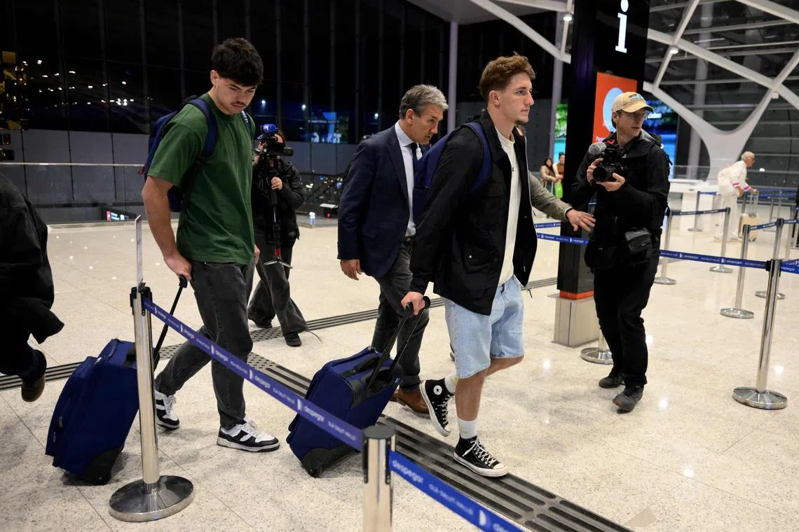French rugby players Hugo Auradou (left) and Oscar Jegou are accompanied by their lawyer as they leave Argentina on Sept 4.
