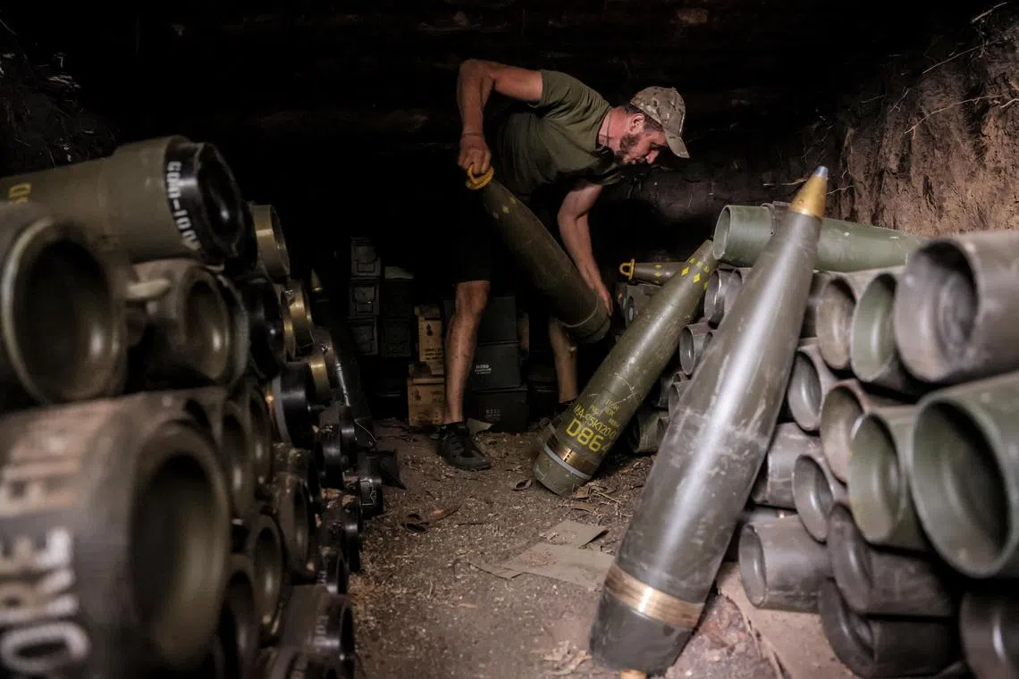 A Ukrainian serviceman prepares shells for firing at Russian positions, near the town of Chasiv Yar in Ukraine's Donetsk region.